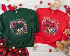 a couple of sweaters sitting on top of a wooden floor