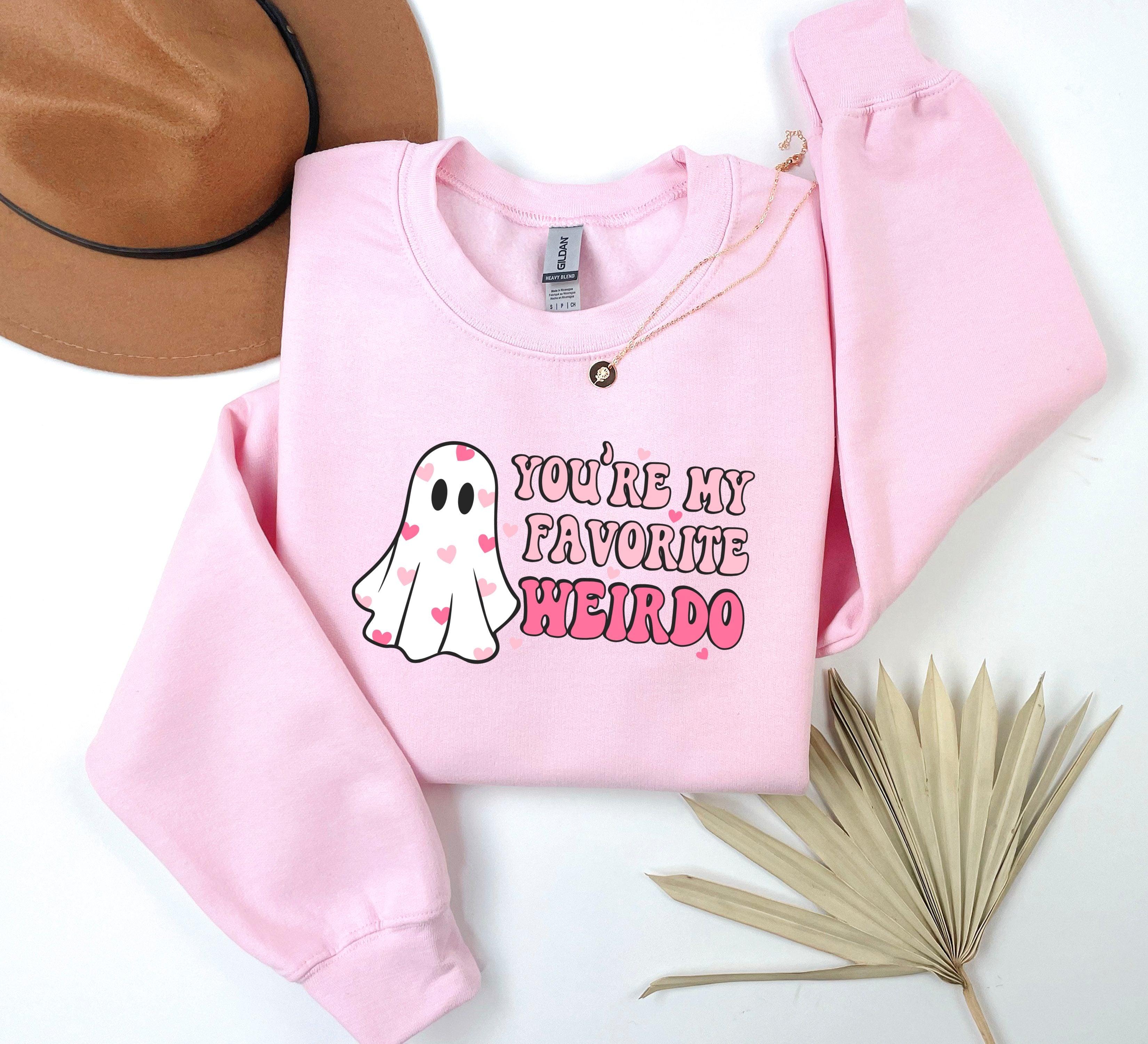 a pink sweatshirt that says you're my favorite weirdo