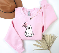 a pink sweater with a ghost on it