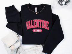 a black sweatshirt with the word valentine vibes on it