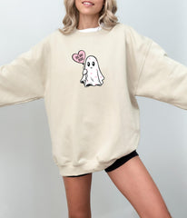 a woman wearing a sweatshirt with a ghost on it