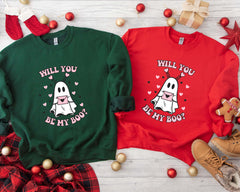 a couple of sweaters that say will you be my boo?