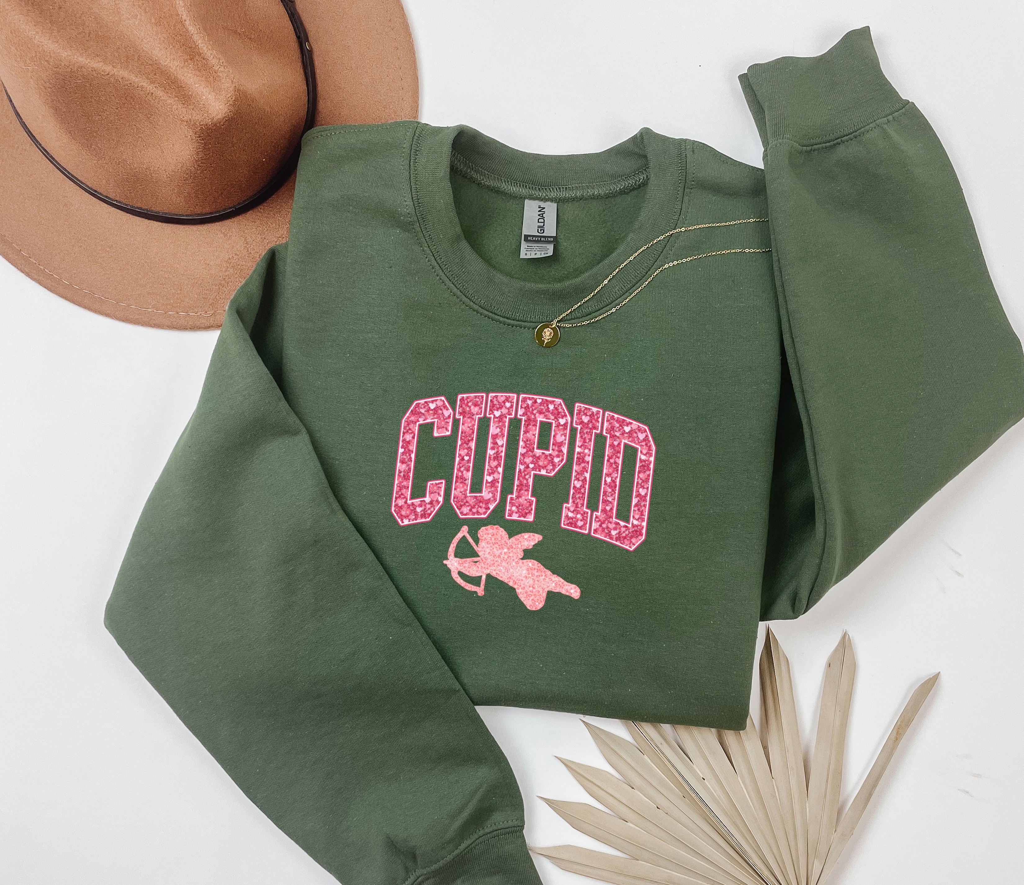 a green sweatshirt with the word cupid printed on it