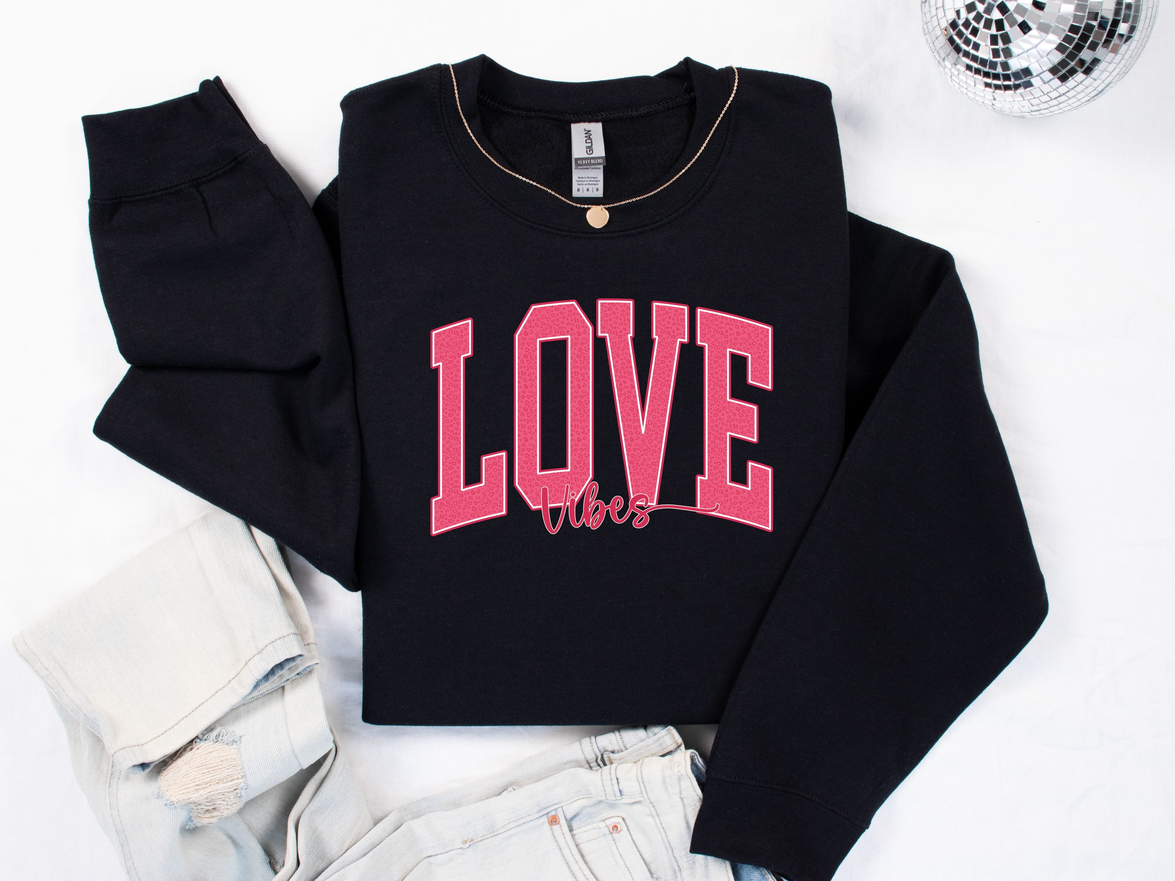 a black sweatshirt with the word love on it