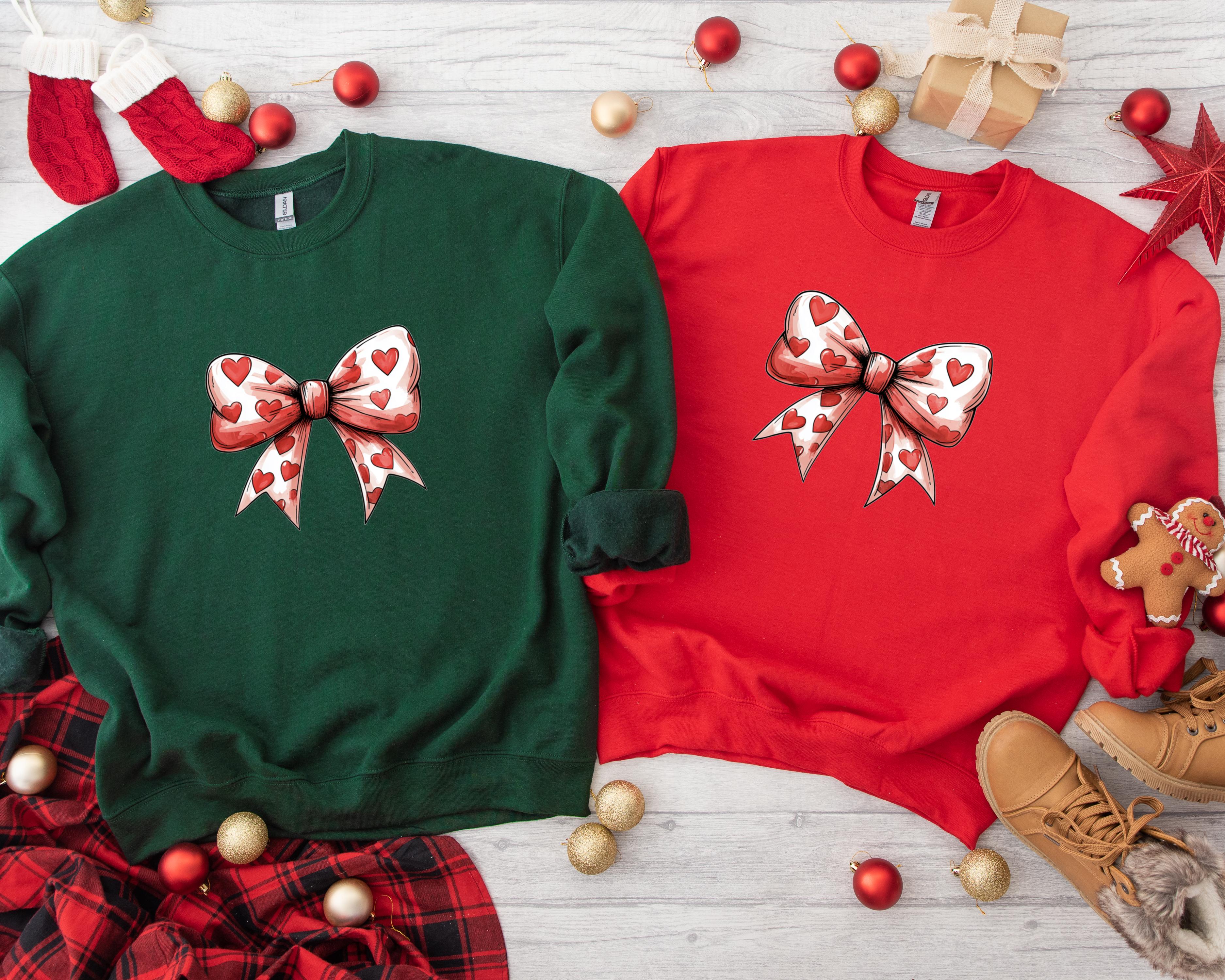 two christmas sweaters with bows on them