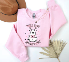 a pink sweatshirt with a cartoon ghost on it