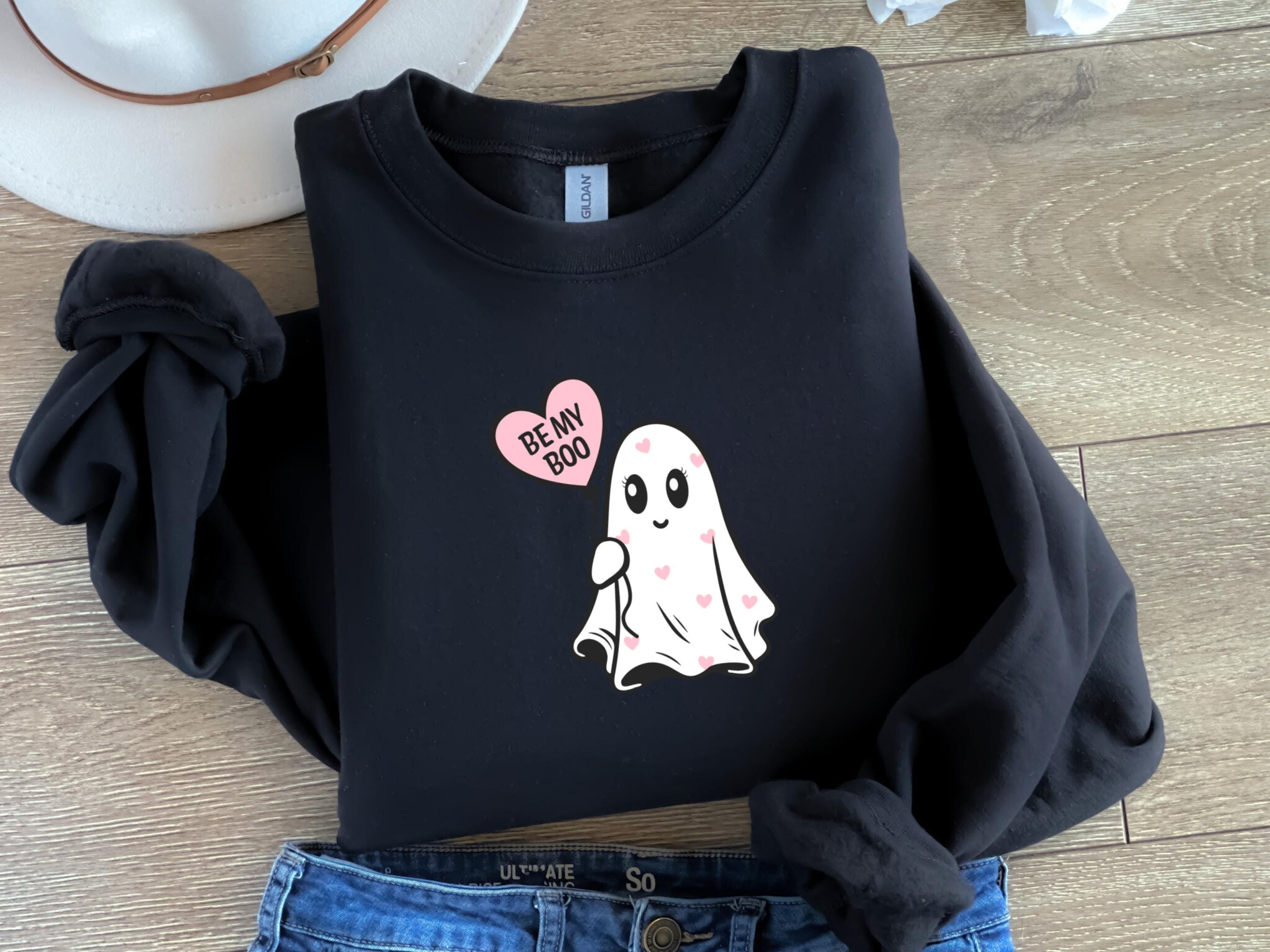 a black shirt with a ghost on it