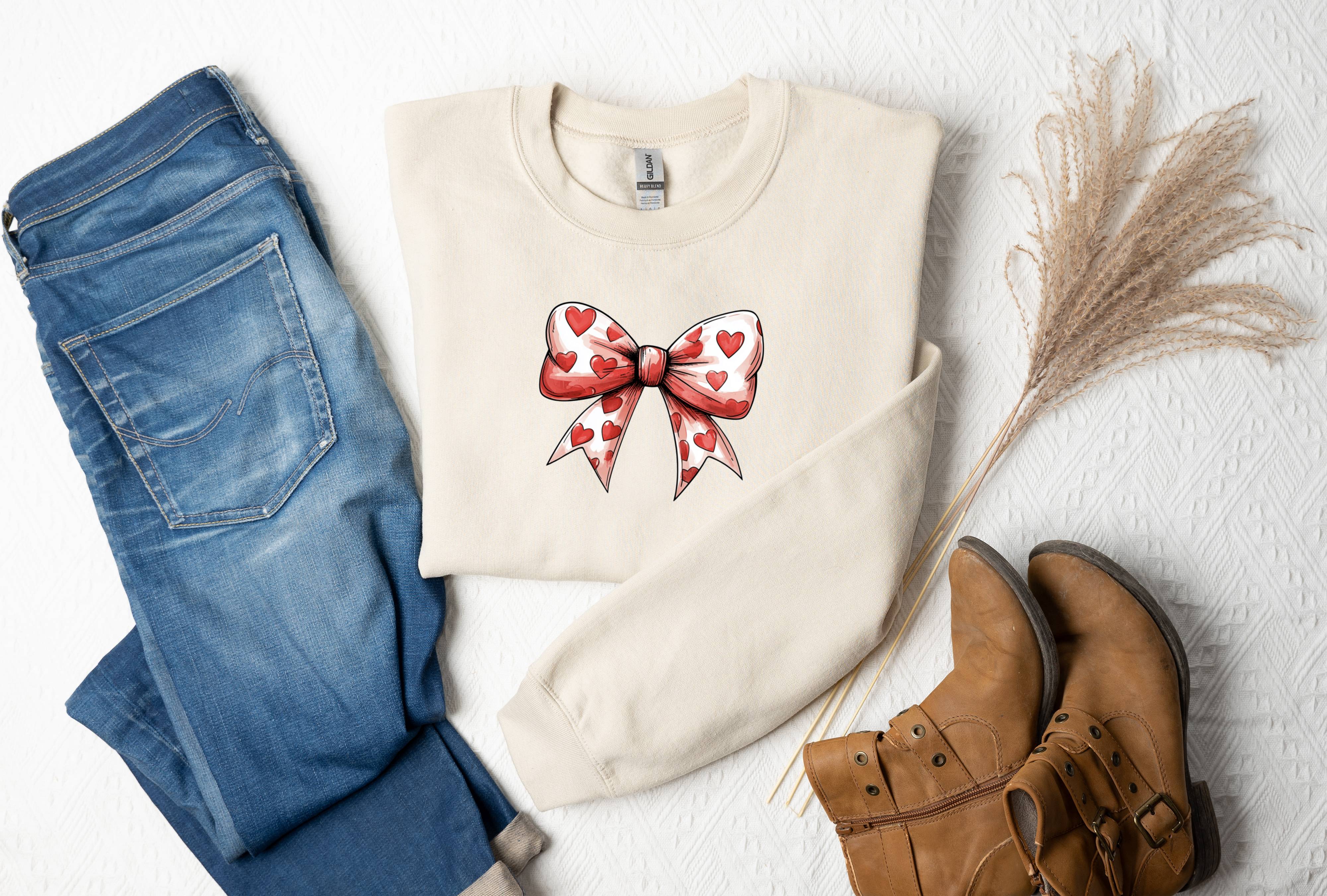 a pair of jeans and a sweater with a bow on it