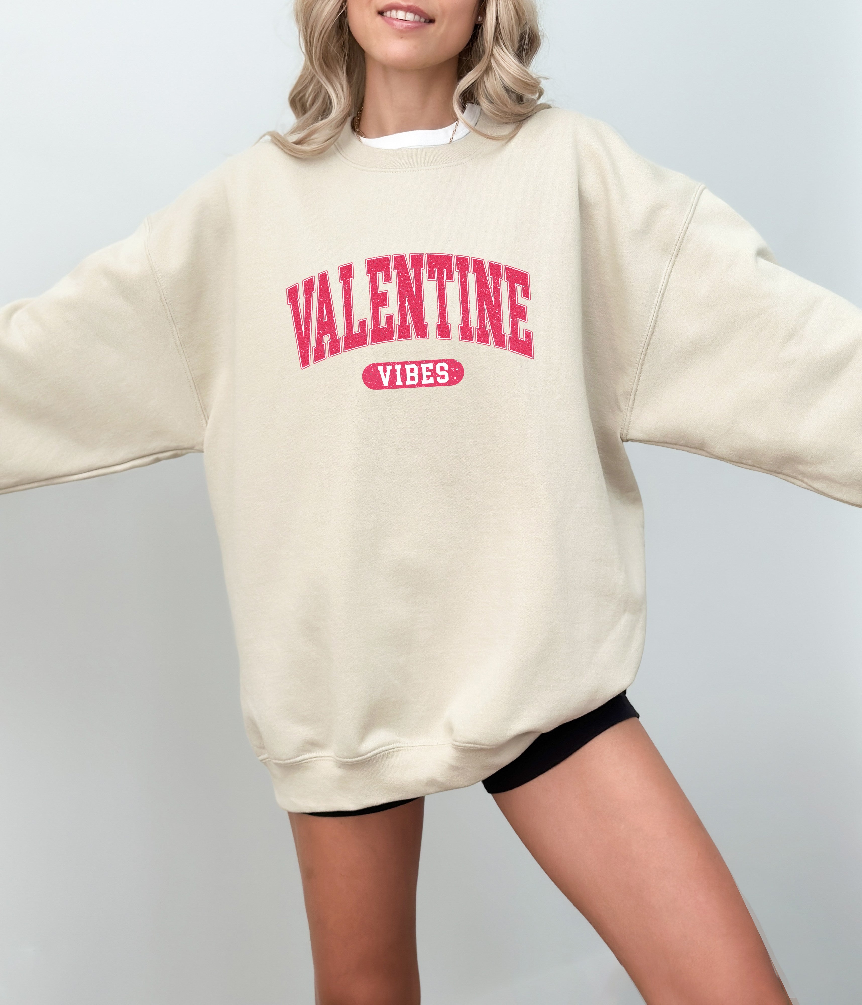 a woman wearing a sweater that says valentine vibe