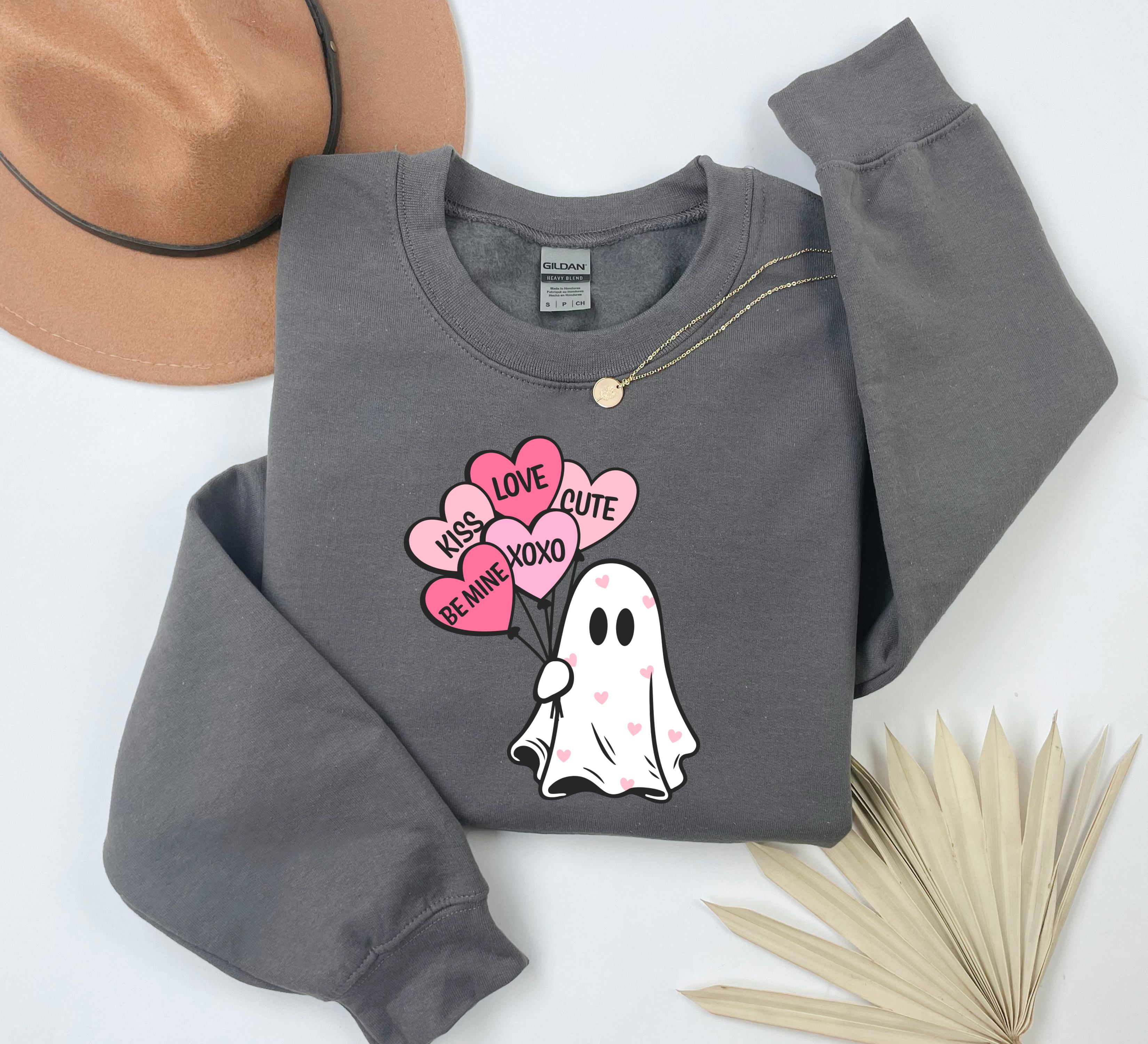 a gray shirt with a ghost holding a heart balloon