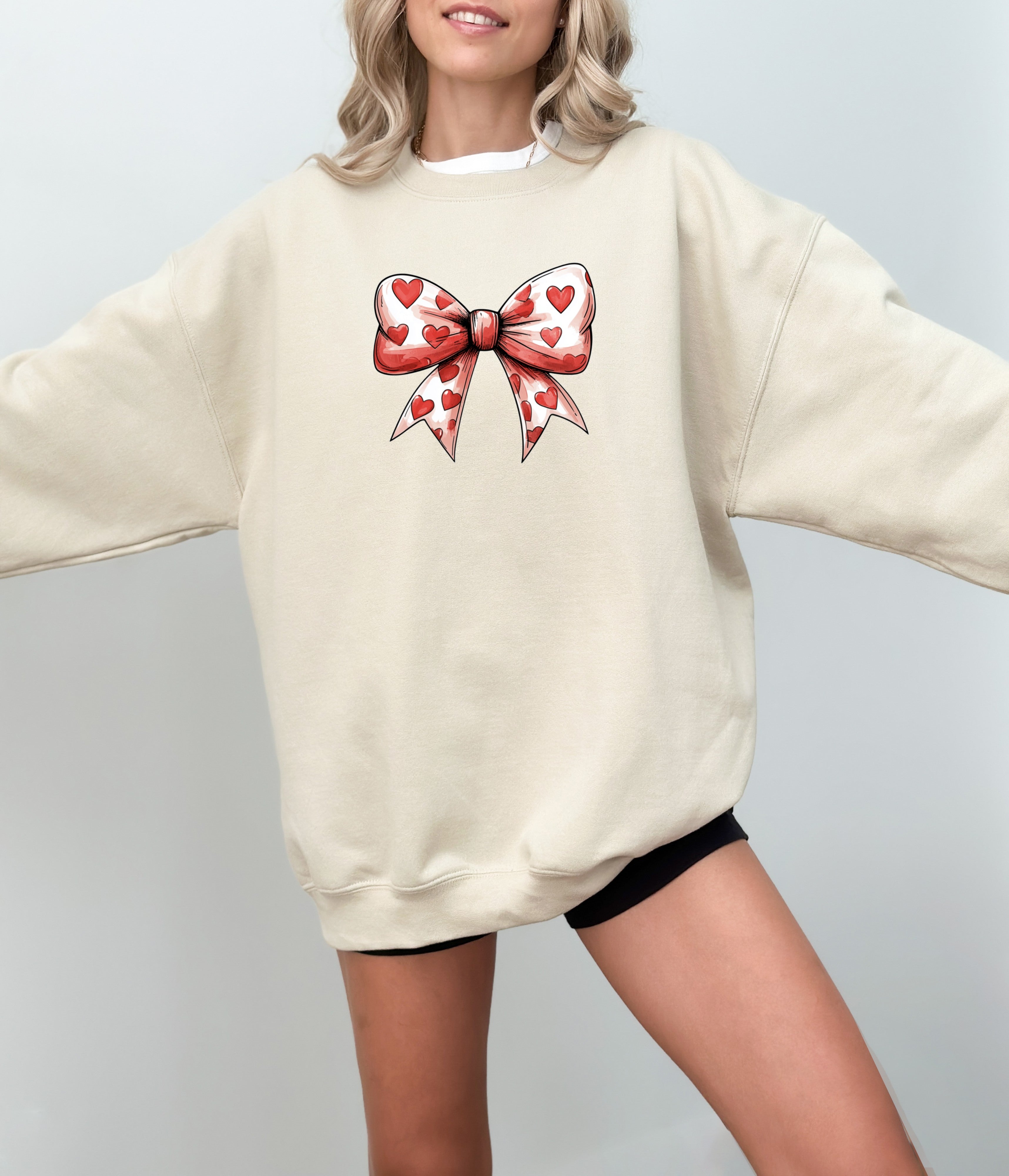 a woman wearing a sweater with a bow on it