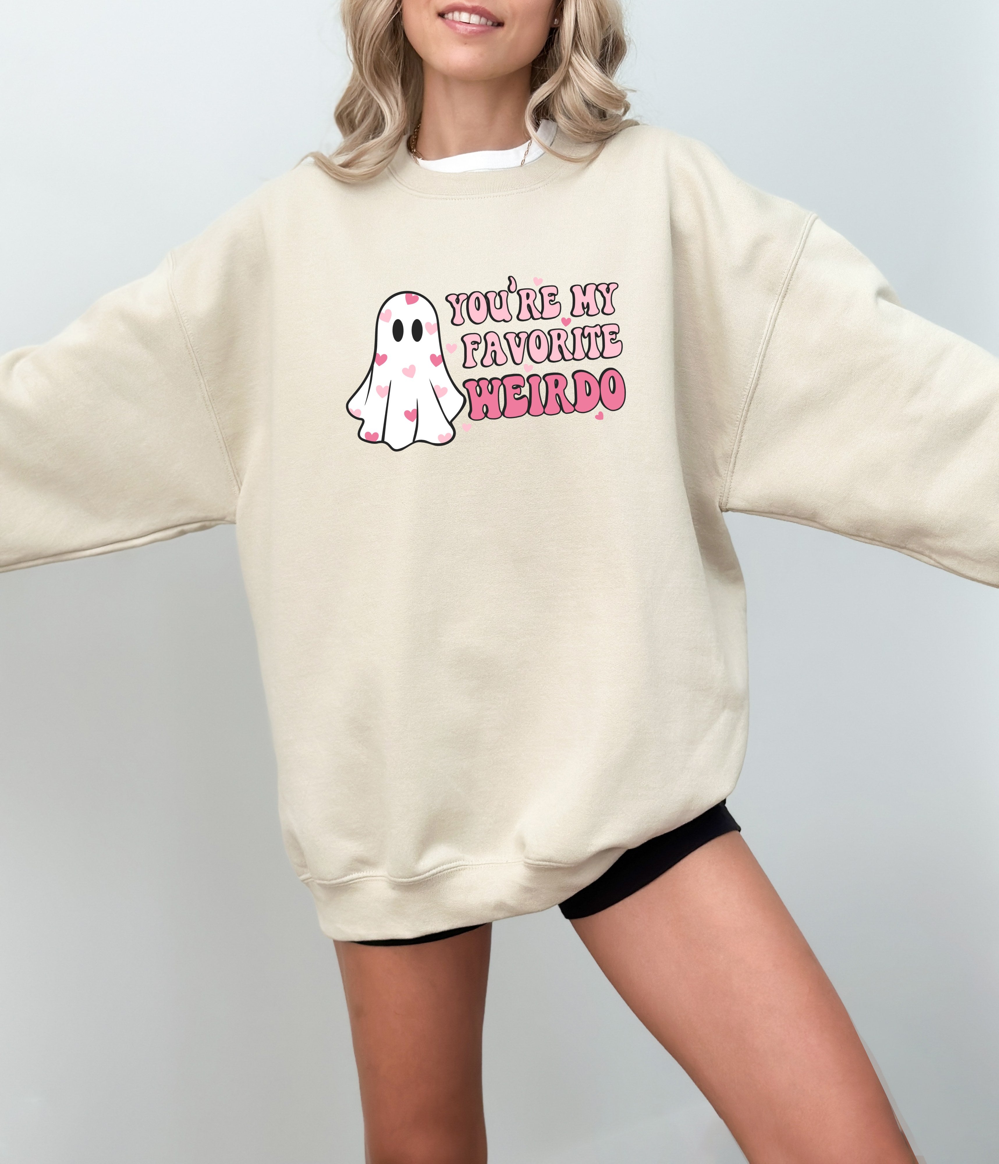 a woman wearing a sweatshirt with a ghost on it