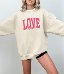 a woman wearing a sweatshirt with the word love on it