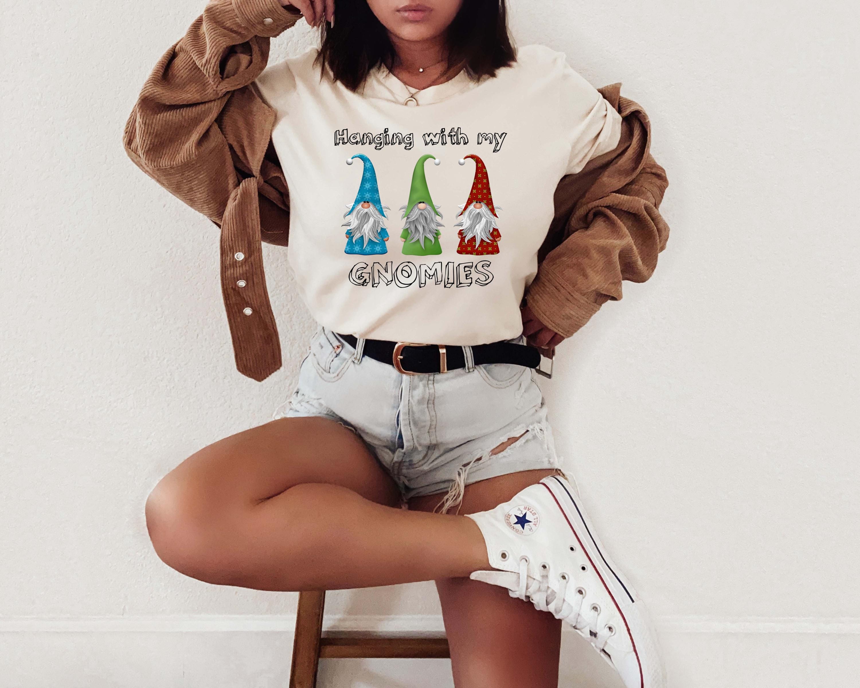 a woman sitting on a stool with her legs crossed