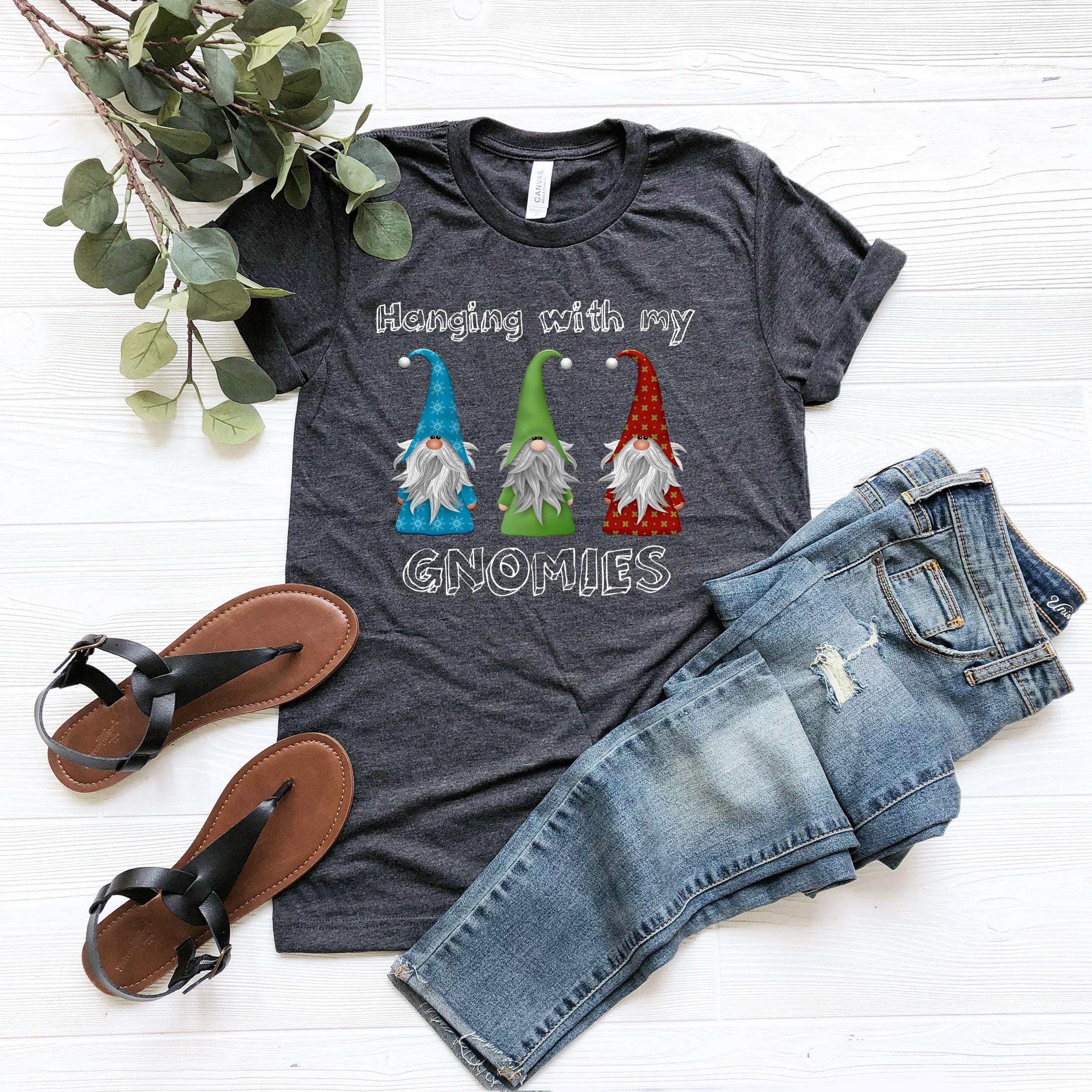 a t - shirt with gnomes on it sitting next to a pair of jeans