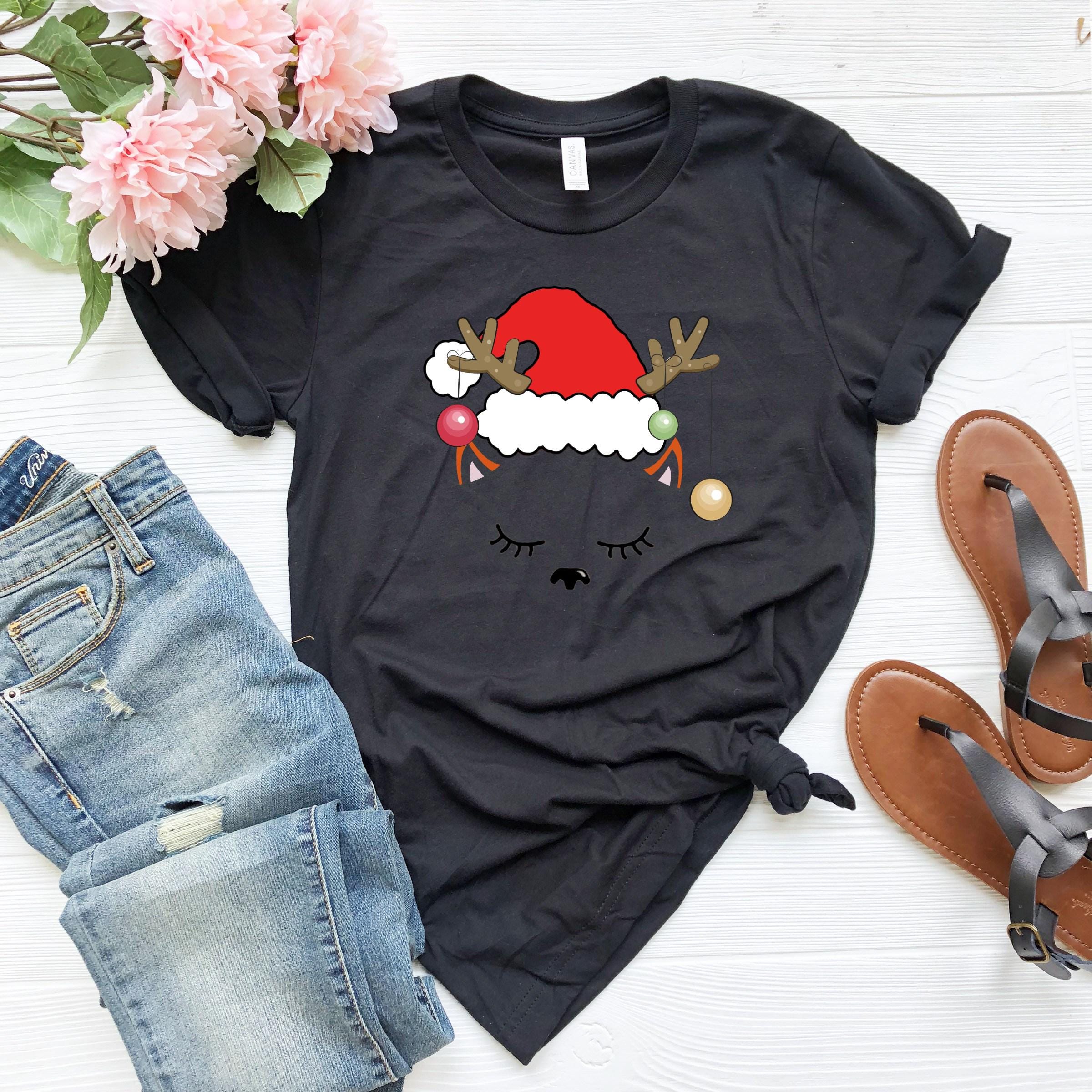 a t - shirt with a santa hat and reindeer antlers on it