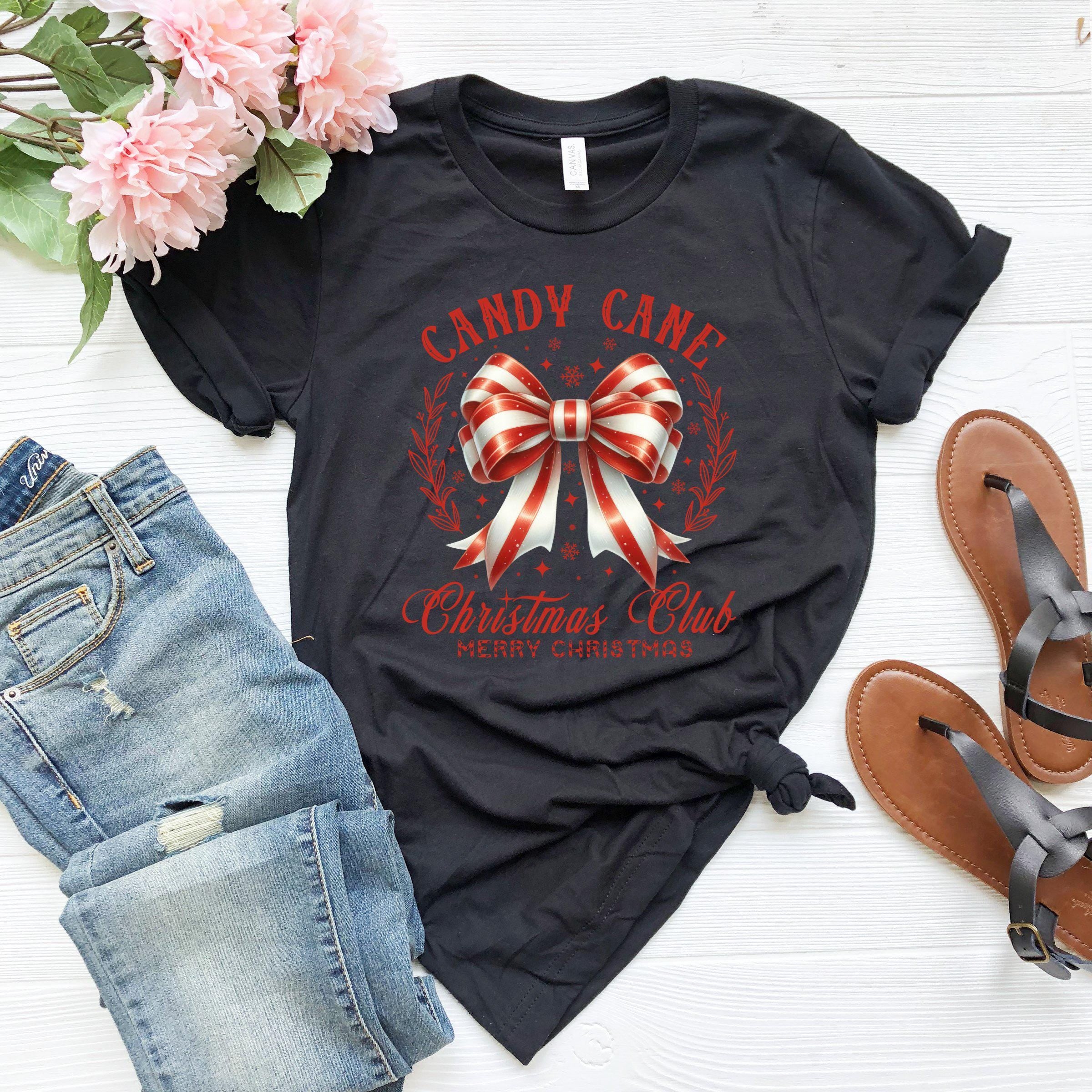 a black t - shirt with a bow and candy cane on it