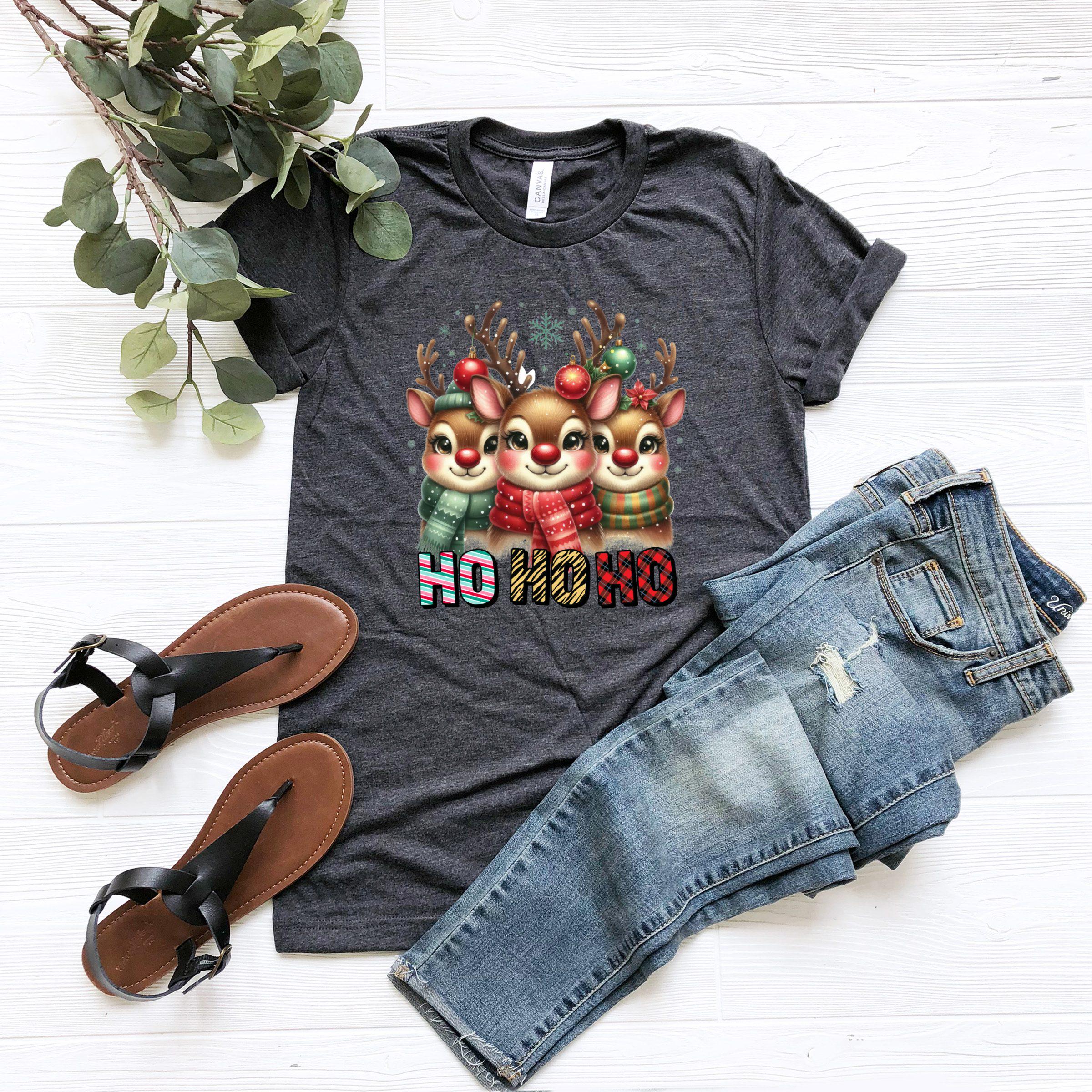 a t - shirt with a christmas design and a pair of jeans