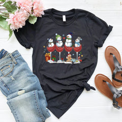 a t - shirt with three snowmen sitting on top of it