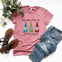 a t - shirt with gnomes on it next to a pair of jeans