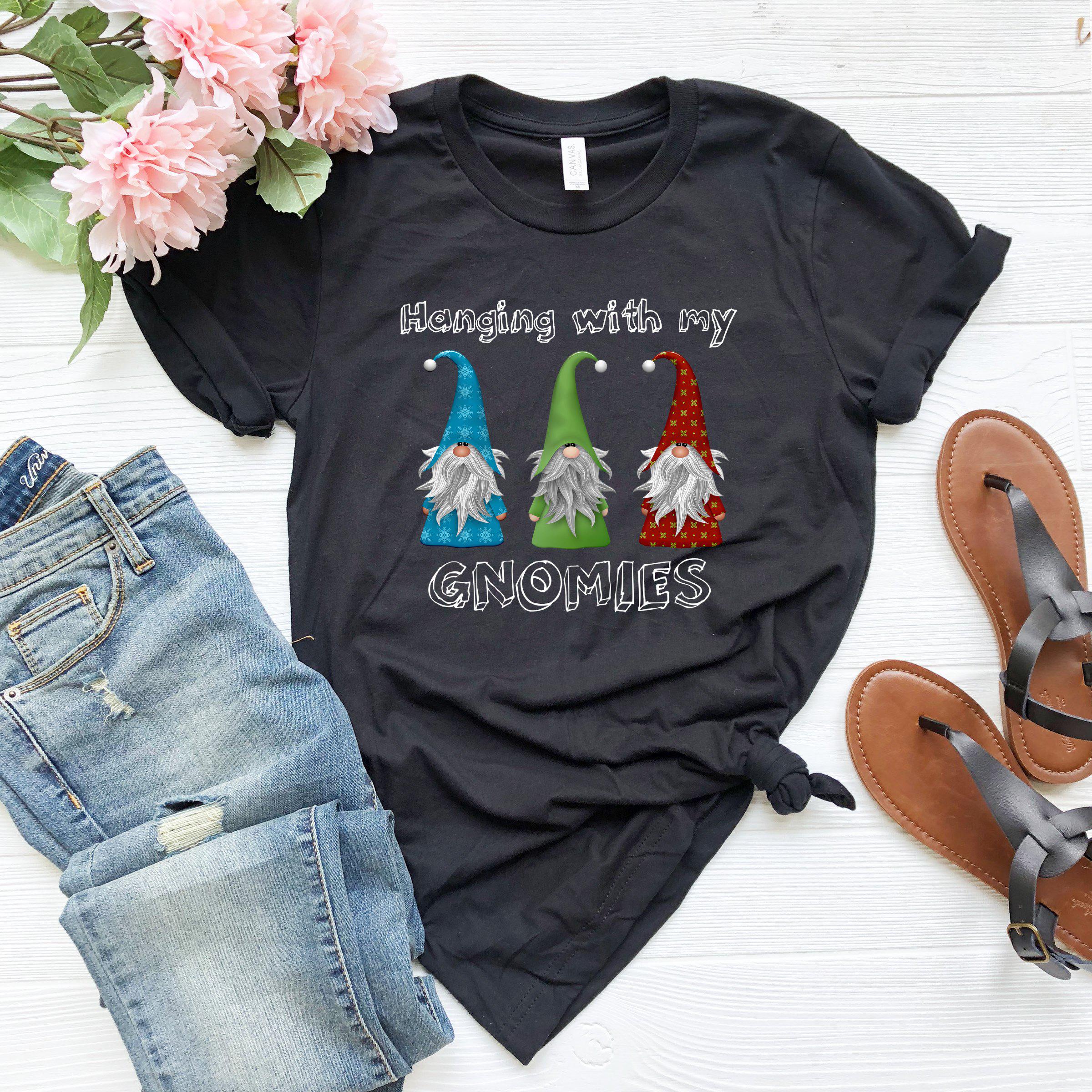 a t - shirt with gnomes on it next to a pair of jeans