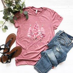 a t - shirt with a pink tree on it next to a pair of jeans