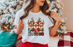 a woman standing in front of a christmas tree