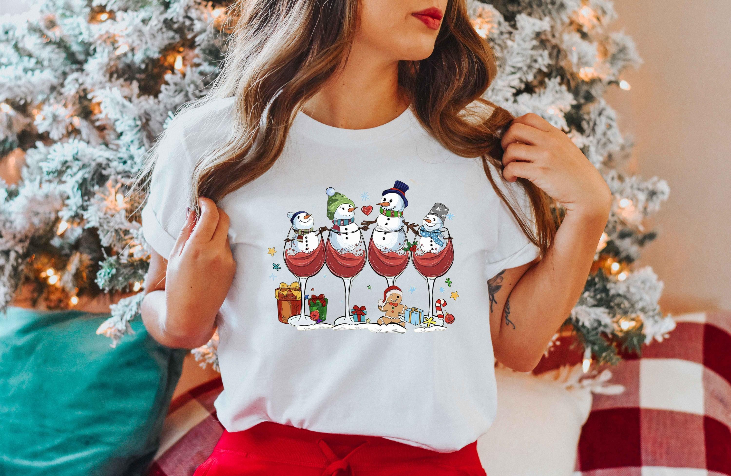 a woman wearing a t - shirt with wine glasses on it